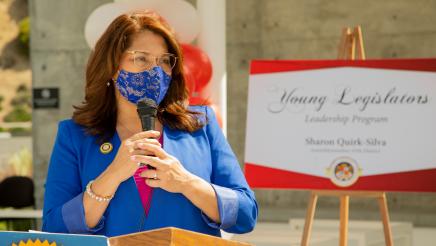 Quirk-Silva speaks to her graduates of the YL Program