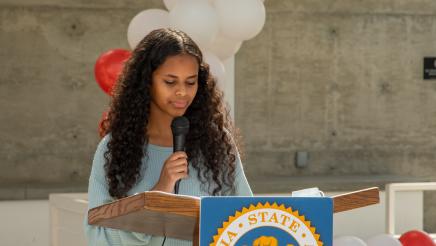 Omnia a graduate speaks to her classmates