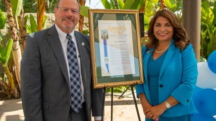 Assemblywoman Sharon Quirk-Silva stands with Gentleman of the Year, Jon Peat