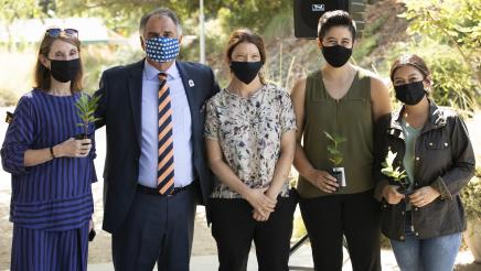 Members of the community and CSUF representatives stand with Doug Chaffee