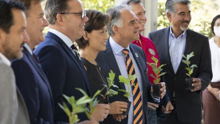 Members stand together in celebration of the reopening of the Fullerton Arboretum